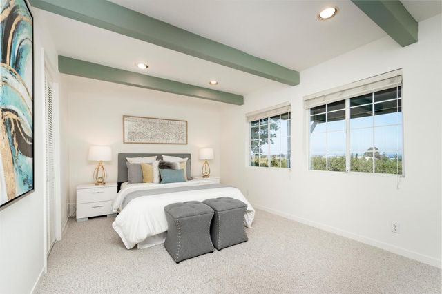 a bedroom with a large bed and a large window