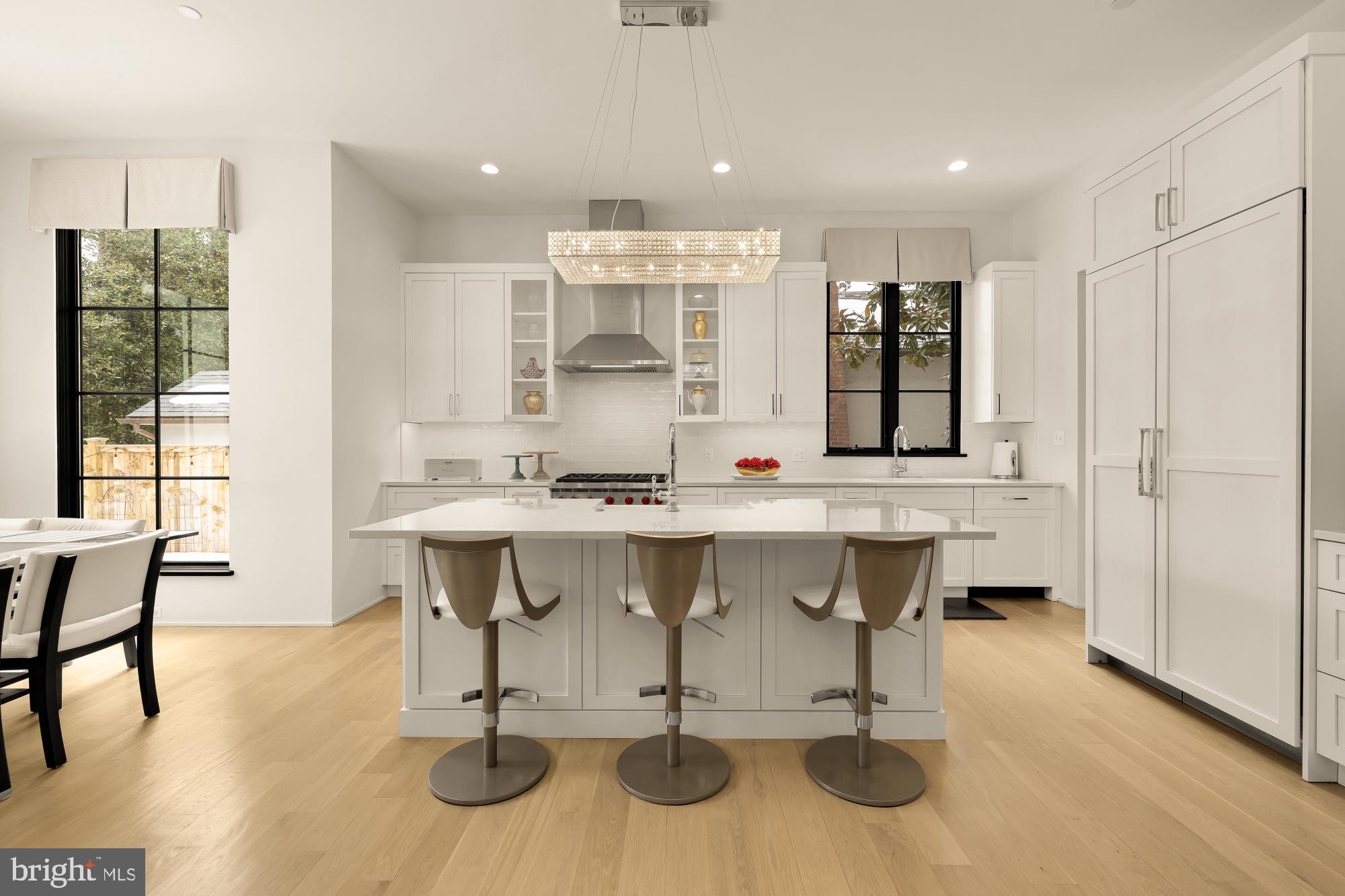 7613 Glenbrook Road Bethesda, MD 20814 - Photo 23 of 90 a kitchen with a sink and chairs