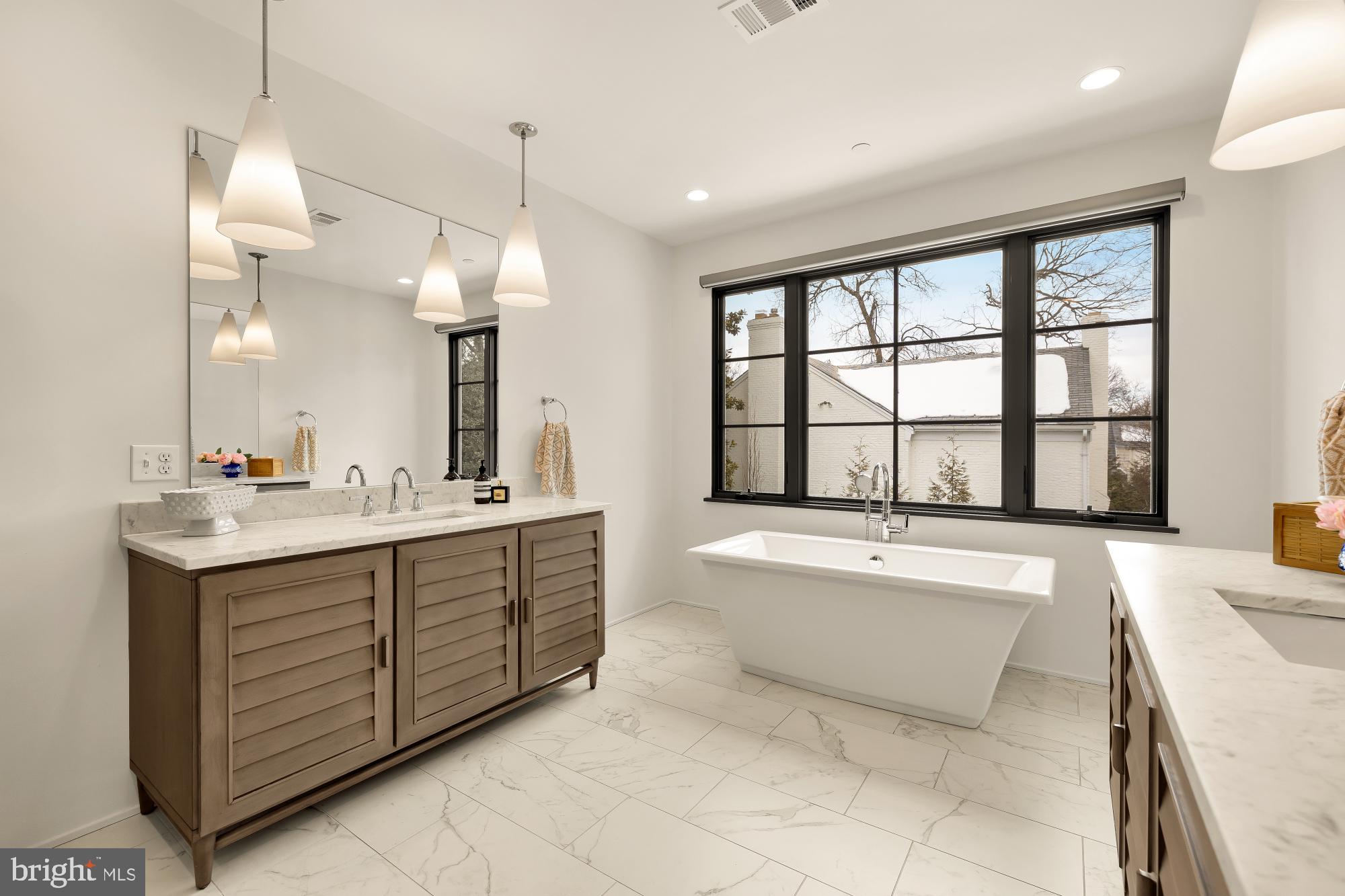 7613 Glenbrook Road Bethesda, MD 20814 - Photo 45 of 90 a spacious bathroom with a granite countertop tub sink and mirror
