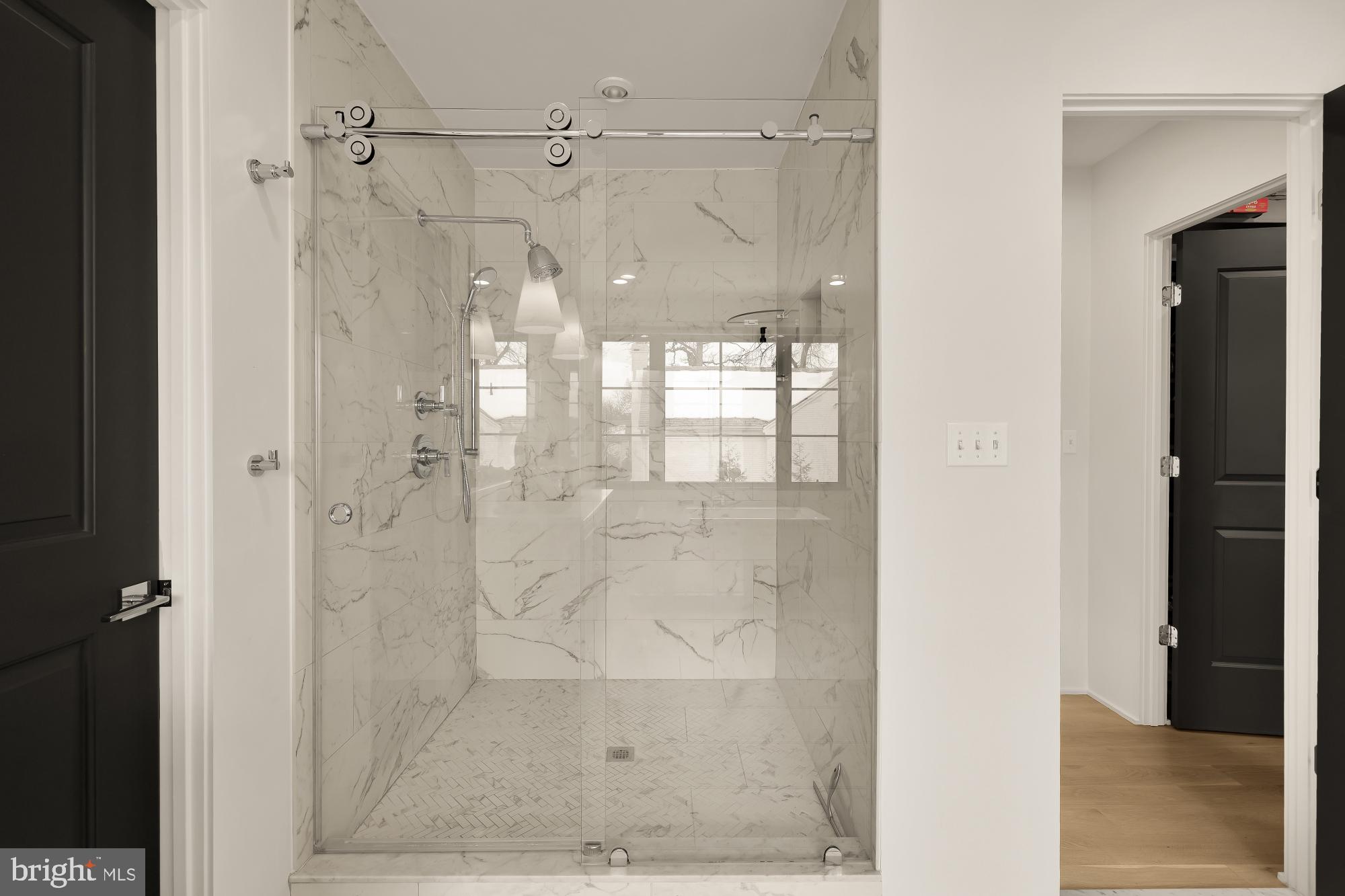 7613 Glenbrook Road Bethesda, MD 20814 - Photo 47 of 90 a bathroom with a glass shower door
