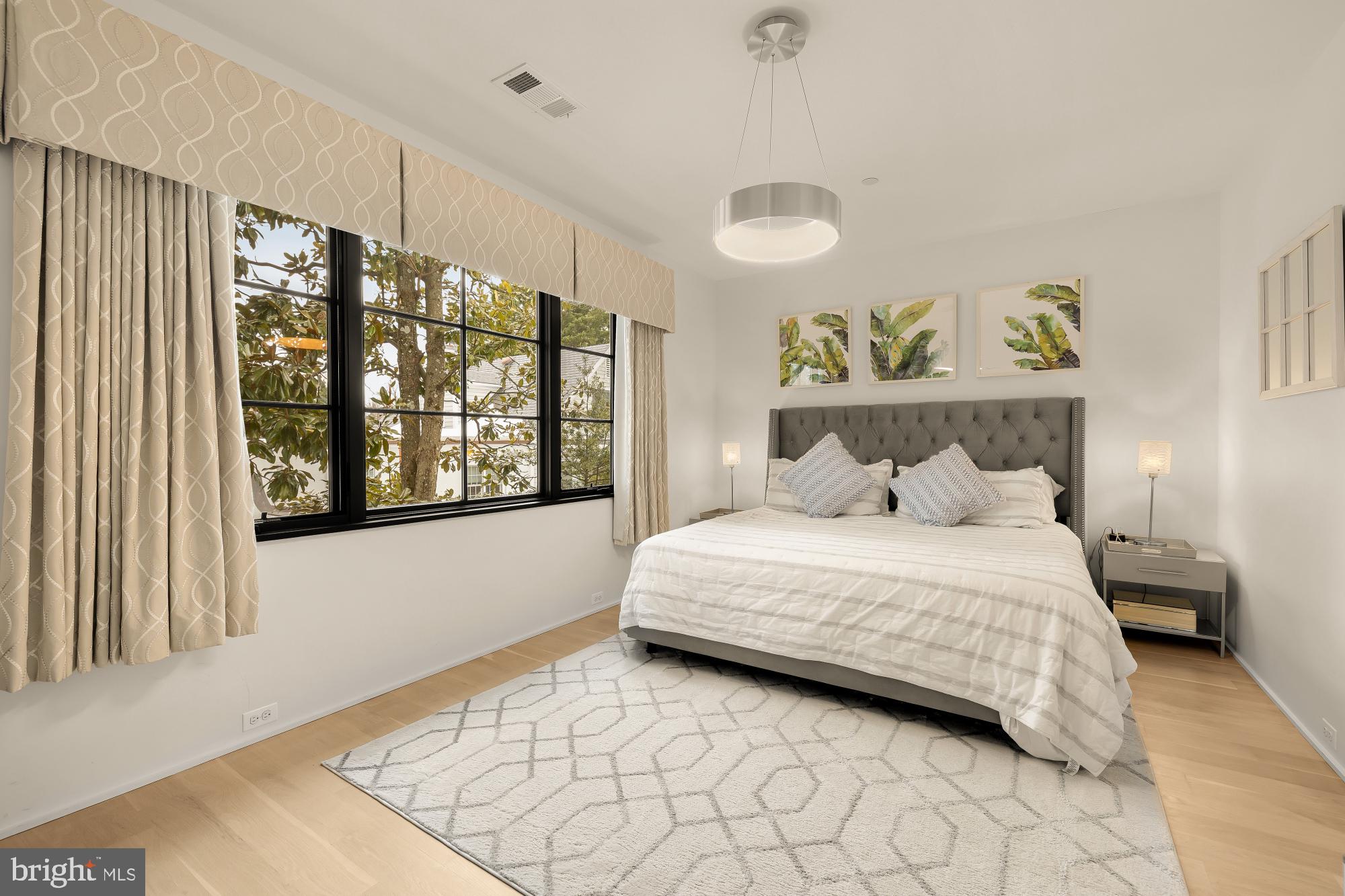 7613 Glenbrook Road Bethesda, MD 20814 - Photo 52 of 90 a bedroom with a large bed and a large window