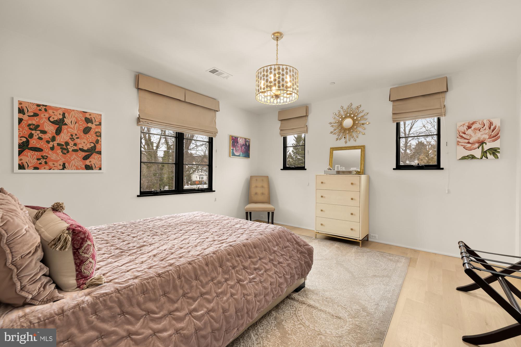 7613 Glenbrook Road Bethesda, MD 20814 - Photo 56 of 90 a bedroom with a bed and a chandelier