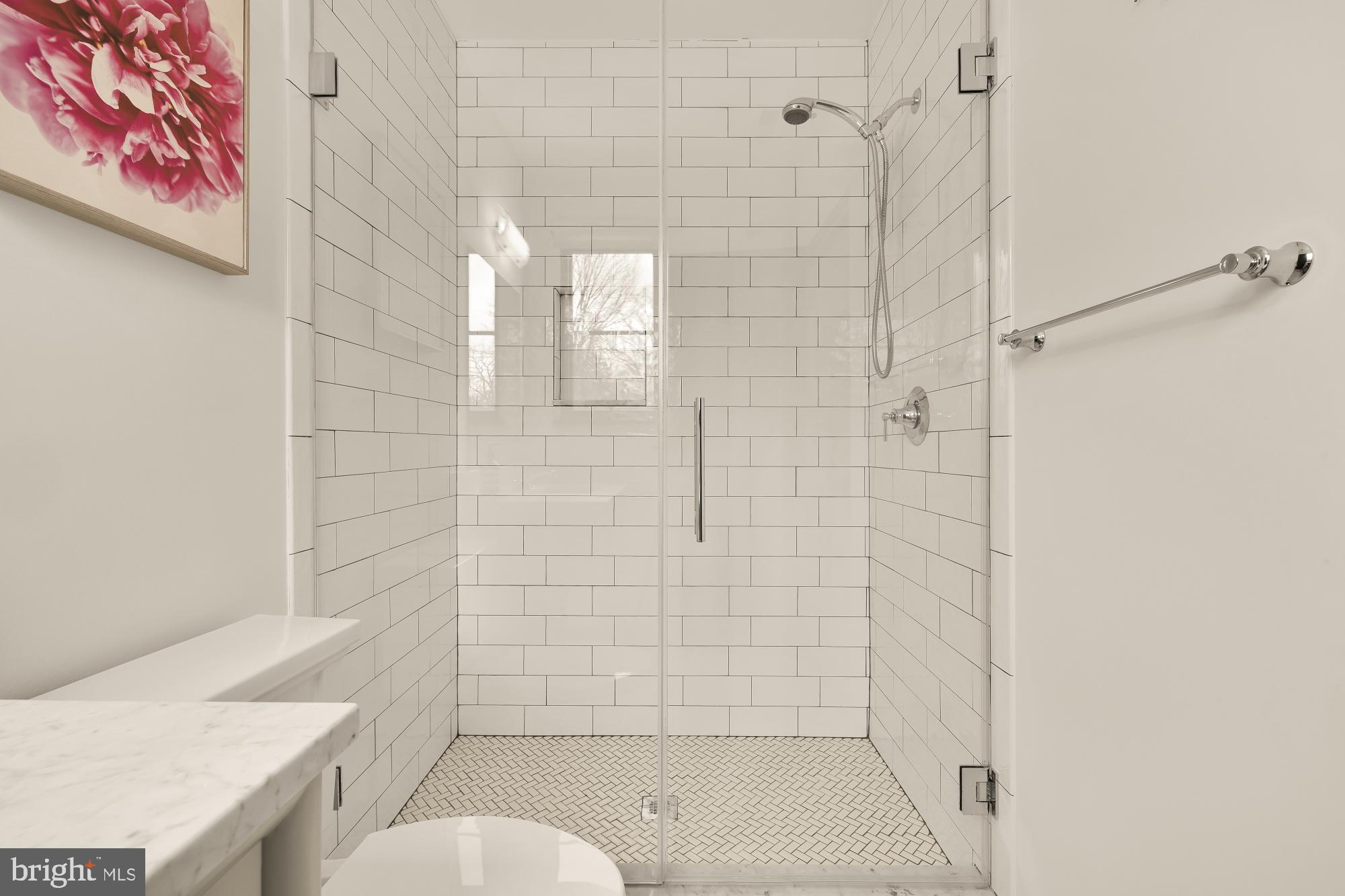 7613 Glenbrook Road Bethesda, MD 20814 - Photo 57 of 90 a bathroom with a shower and toilet