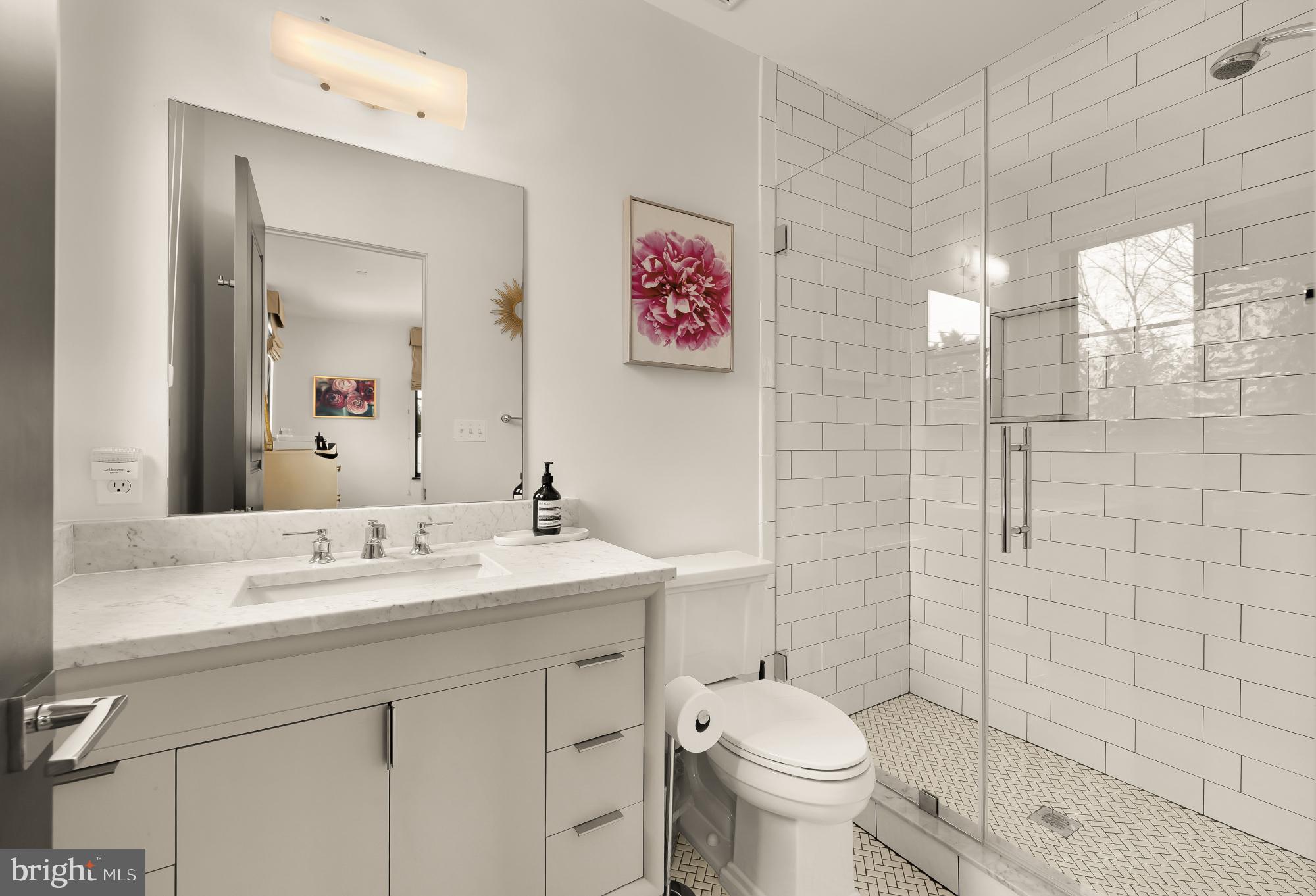 7613 Glenbrook Road Bethesda, MD 20814 - Photo 60 of 90 a bathroom with a toilet sink and mirror