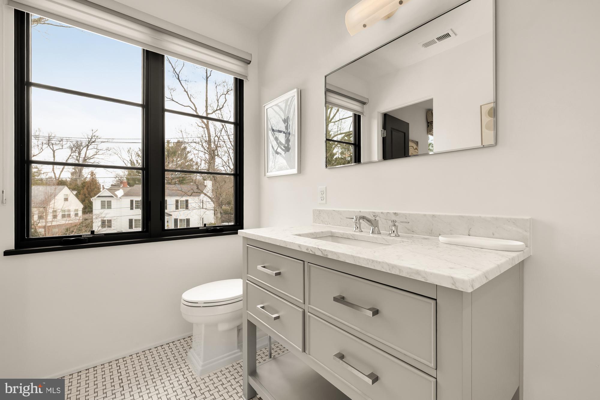 7613 Glenbrook Road Bethesda, MD 20814 - Photo 63 of 90 a bathroom with a granite countertop sink mirror and a toilet