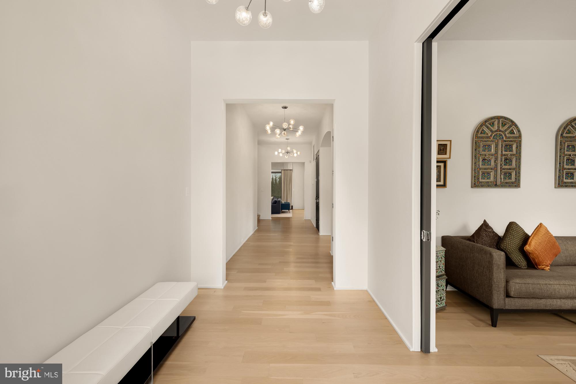 7613 Glenbrook Road Bethesda, MD 20814 - Photo 8 of 90 a hallway with a couch and wooden floor