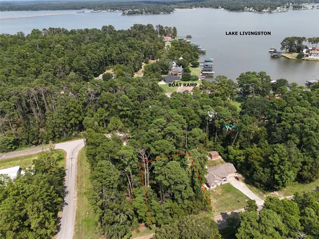 an aerial view of a house with a yard and lake view