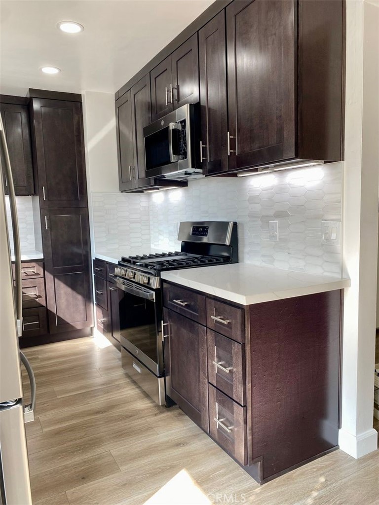241 Newport Avenue, Unit 5 Long Beach, CA 90803 - Photo 4 of 8 a kitchen with stainless steel appliances granite countertop a stove a sink and a refrigerator