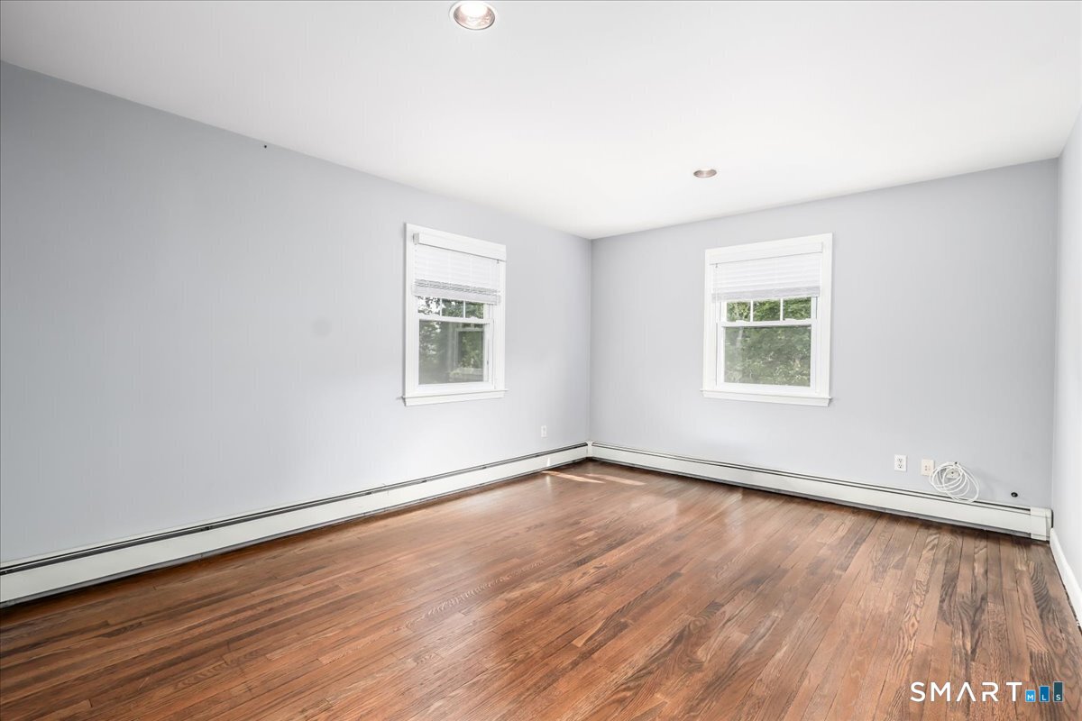 19 Botsford Hill Road Newtown, CT 06470 - Photo 22 of 40 an empty room with wooden floor and windows