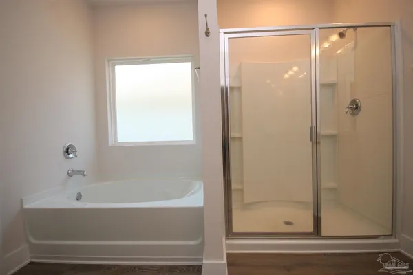 a bathroom with a bathtub and shower