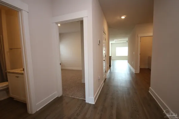 a view of a hallway with wooden floor
