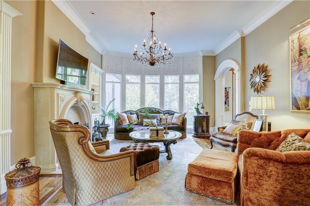 3455 Rivers Call Boulevard Atlanta, GA 30339 - Photo 21 of 53 a living room with furniture a chandelier and a fireplace