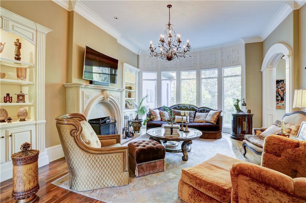 3455 Rivers Call Boulevard Atlanta, GA 30339 - Photo 22 of 53 a living room with furniture a fireplace and a chandelier