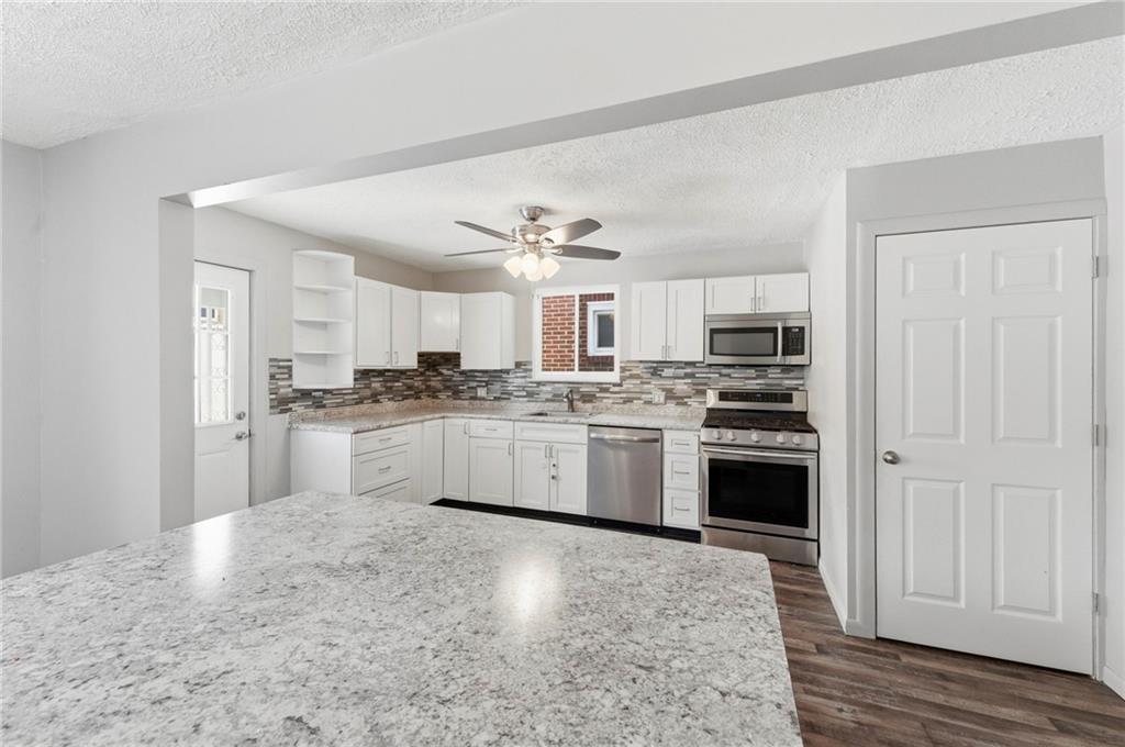 1620 Ridge Avenue New Kensington, PA 15068 - Photo 12 of 33 a kitchen with granite countertop white cabinets and stainless steel appliances