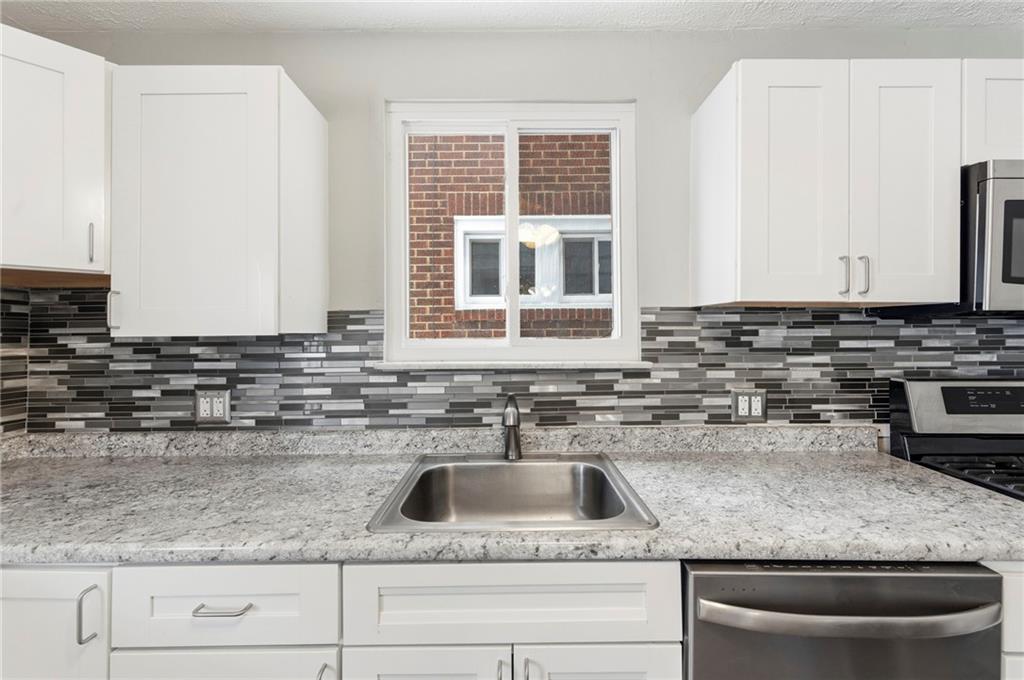 1620 Ridge Avenue New Kensington, PA 15068 - Photo 13 of 33 a kitchen with kitchen island granite countertop a sink stainless steel appliances and cabinets