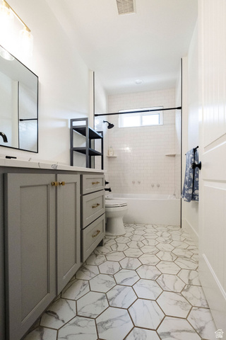 924 Country Lane Farmington, UT 84025 - Photo 36 of 91 Bathroom featuring hexagon marble-look floor tiles, a light gray vanity with gold-tone hardware, a white subway tile bath surround, and a tub with a black shower fixture