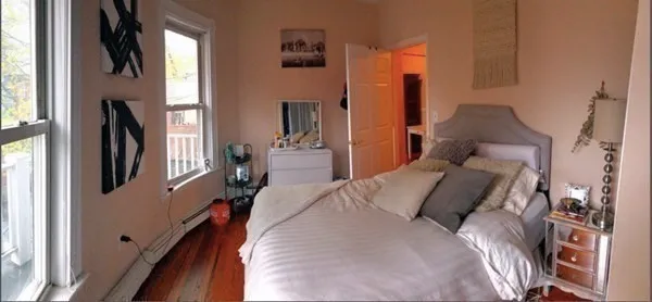 a bed sitting in a bedroom next to a window