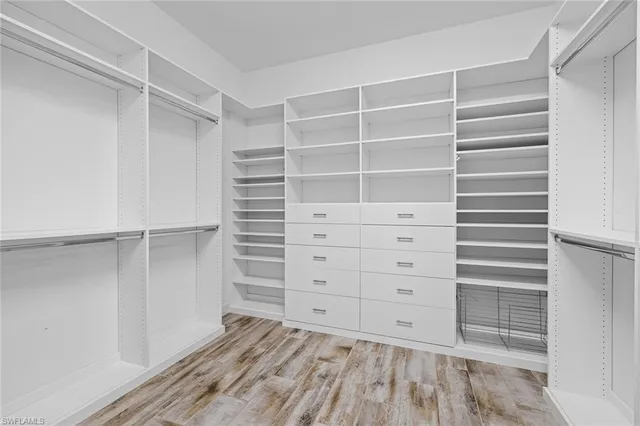 a view of walk in closet with empty racks
