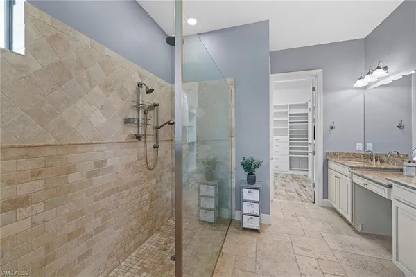 a bathroom with a granite countertop sink a toilet and shower
