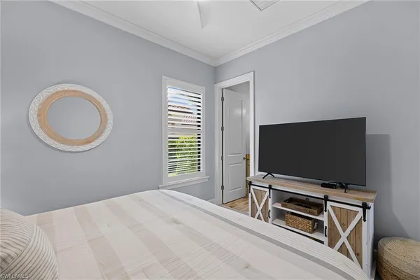 a bedroom with bed and a flat screen tv