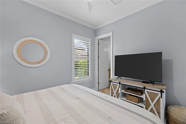 a bedroom with bed and a flat screen tv