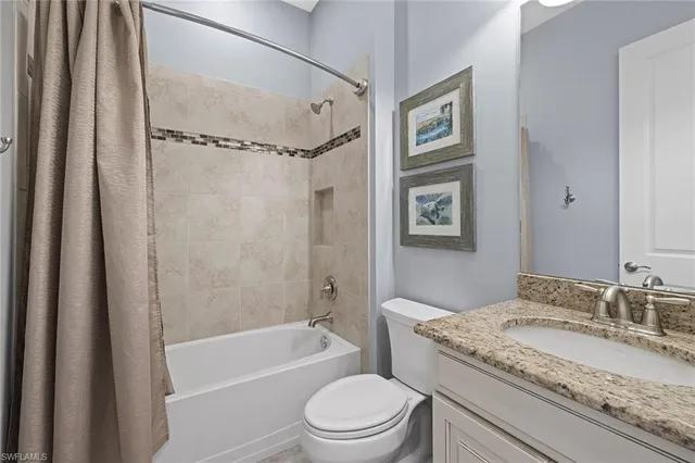 a bathroom with a granite countertop sink toilet tub and shower