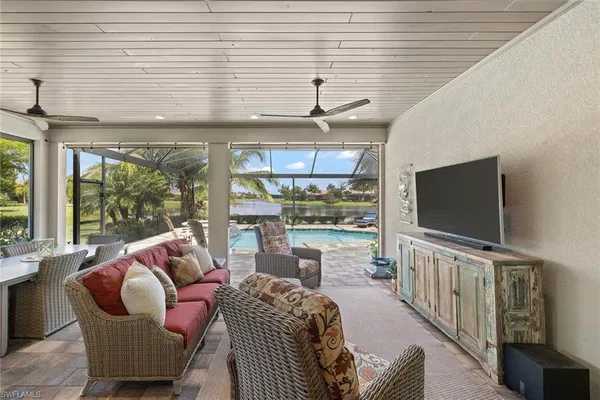 a living room with furniture tv and a large window