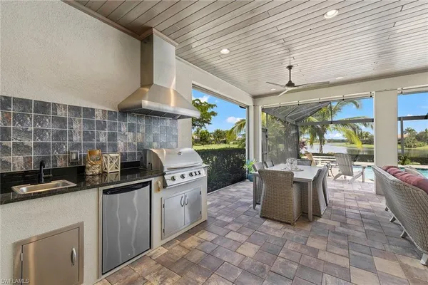 a kitchen with stainless steel appliances granite countertop a sink and cabinets