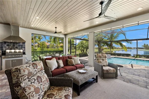 a living room with furniture and a floor to ceiling window