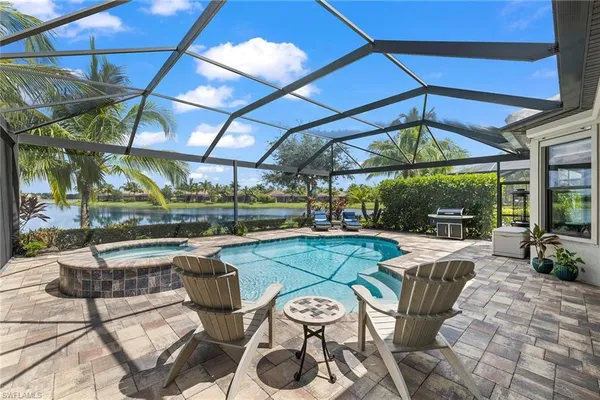 a view of a patio with a dining table and chairs under an umbrella