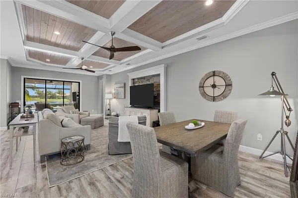 a living room with furniture a flat screen tv and a table