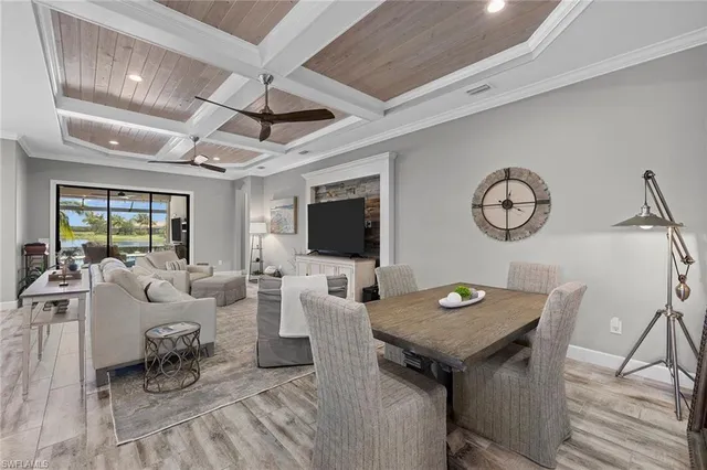 a living room with furniture a flat screen tv and a table