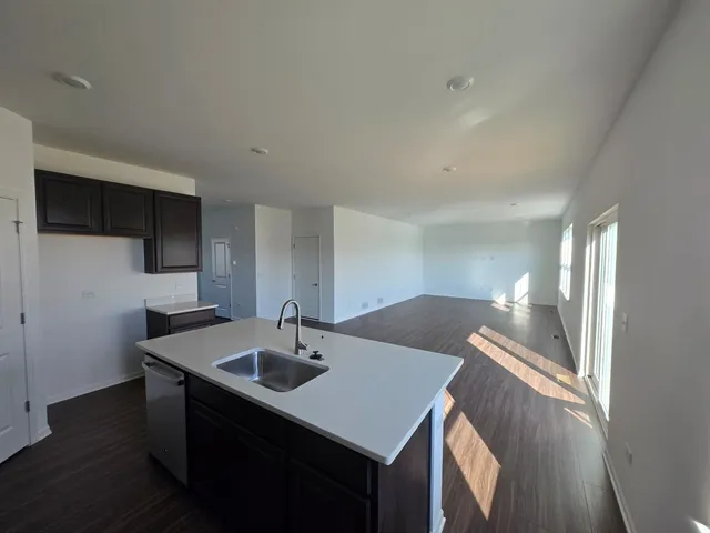 a kitchen that has a sink and a table in it