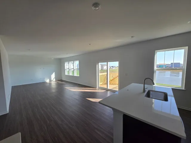 a view of a workspace with wooden floor and a window