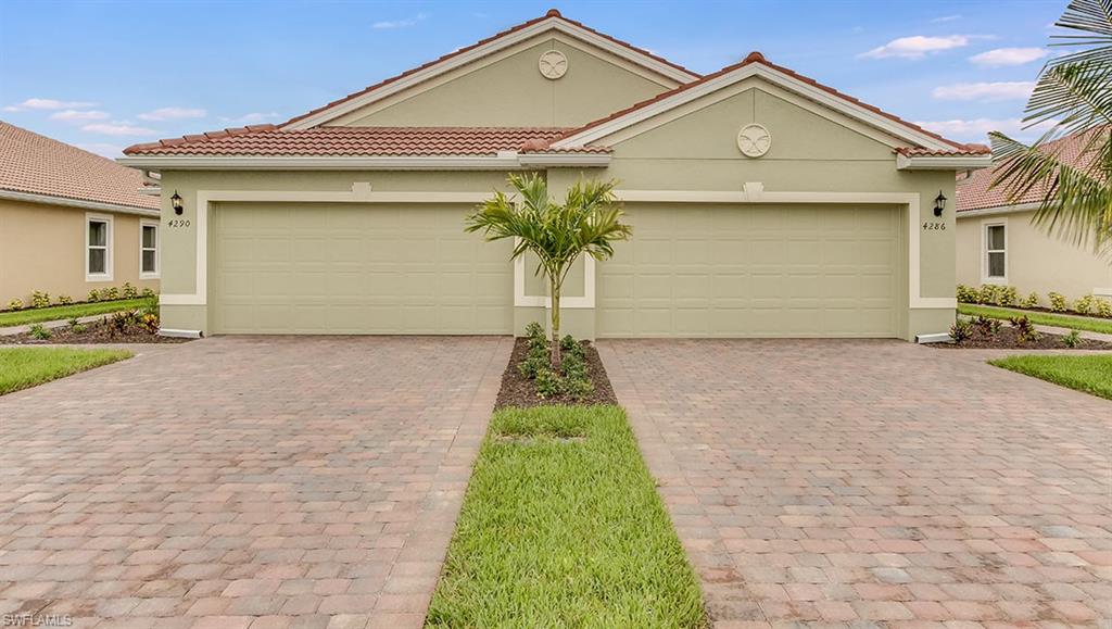a front view of a house with a yard and garage