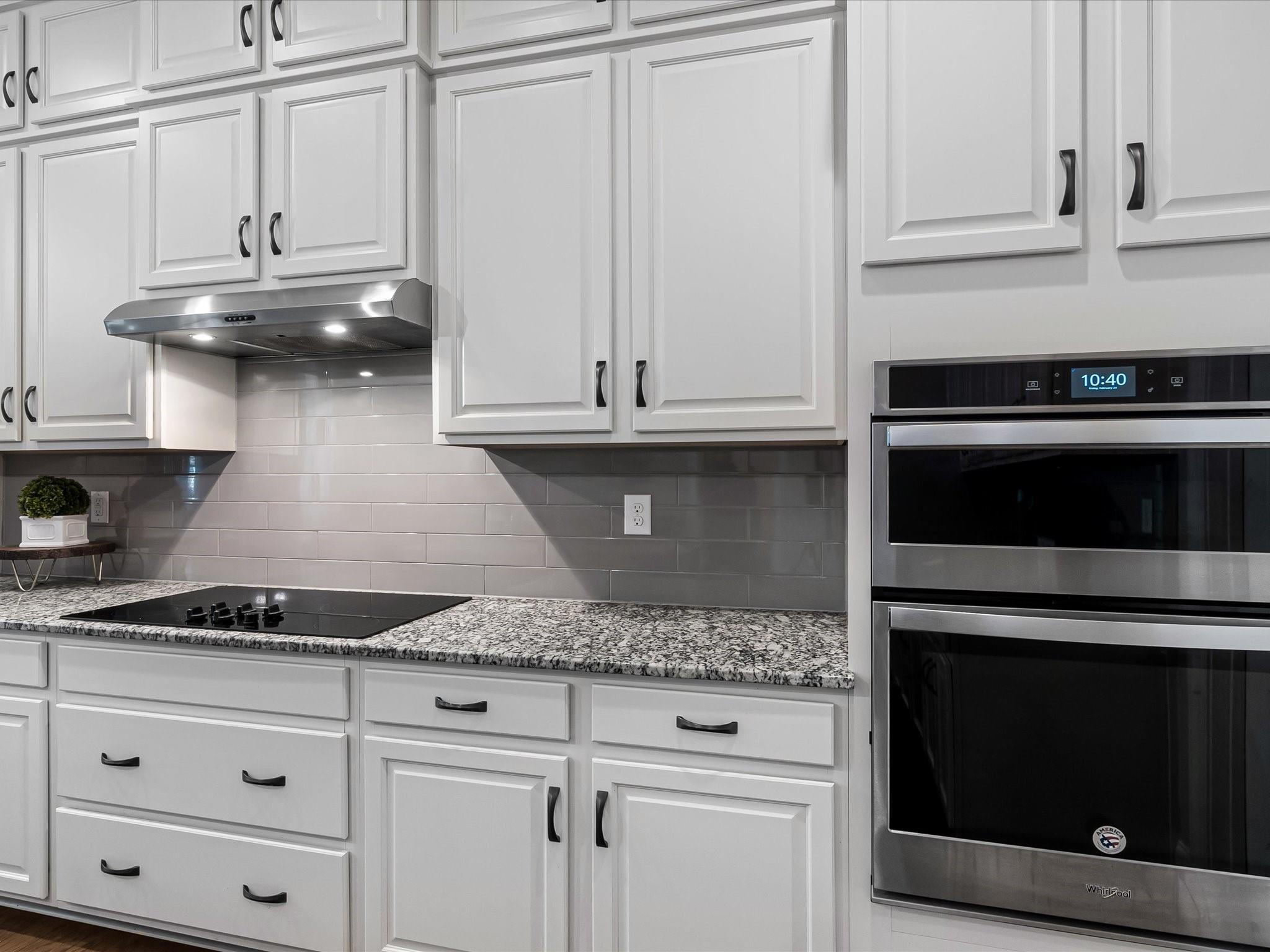 4876 Killian Crossing Drive Denver, NC 28037 - Photo 12 of 46 a kitchen with granite countertop white cabinets and a stove