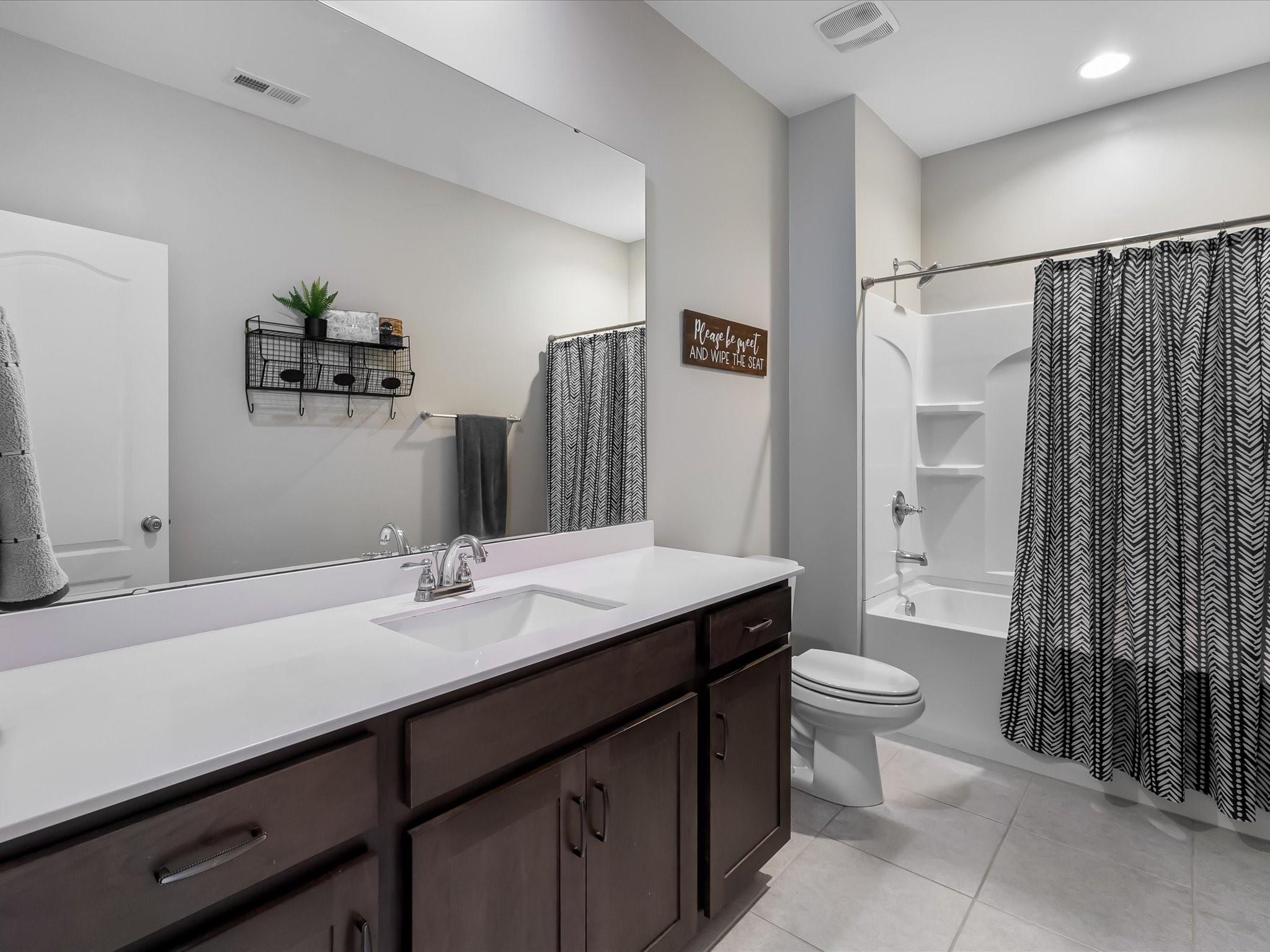 4876 Killian Crossing Drive Denver, NC 28037 - Photo 30 of 46 a bathroom with a sink a toilet and a large mirror