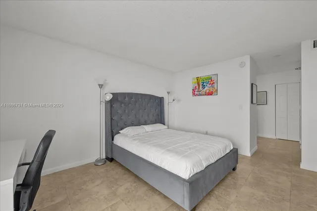 a bedroom with a bed and a chair