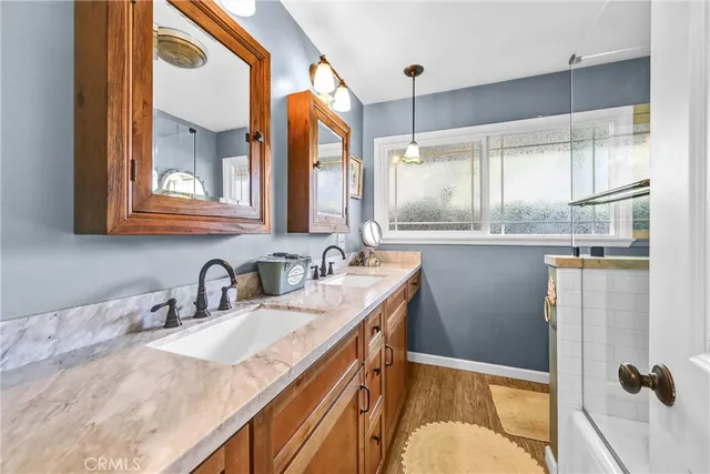 a bathroom with a sink a mirror and a shower