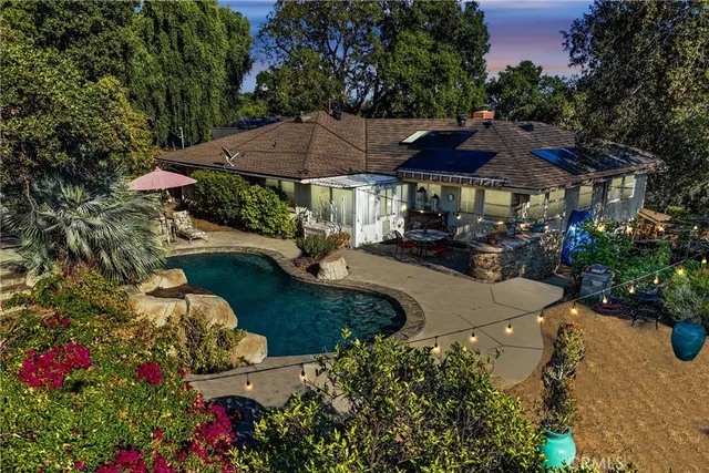 a view of a chairs and table in patio with a lake view