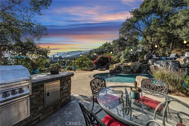 a view of a house with swimming pool and sitting area