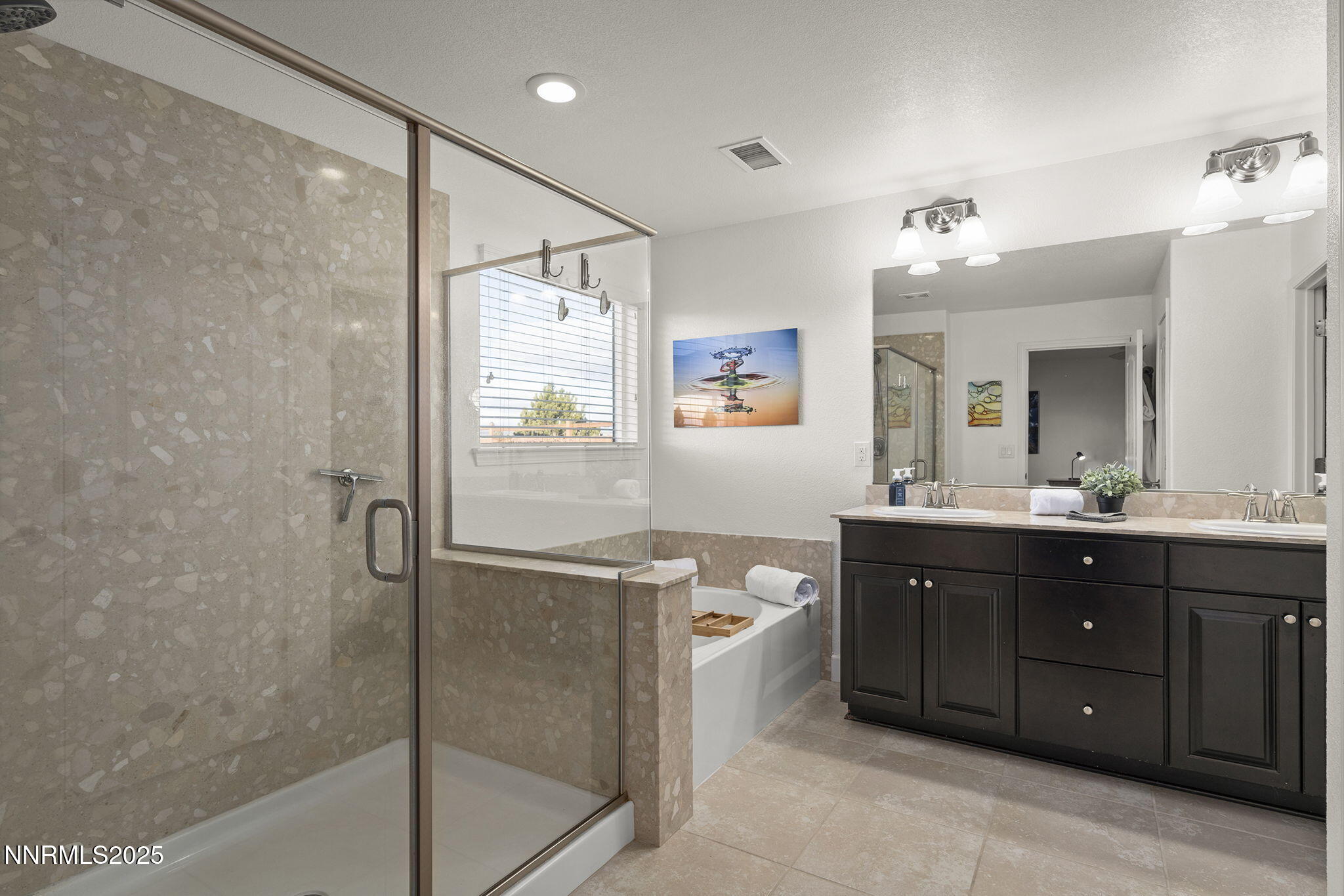 7707 Rhythm Circle Sparks, NV 89436 - Photo 12 of 30 a spacious bathroom with a granite countertop sink mirror and a bathtub
