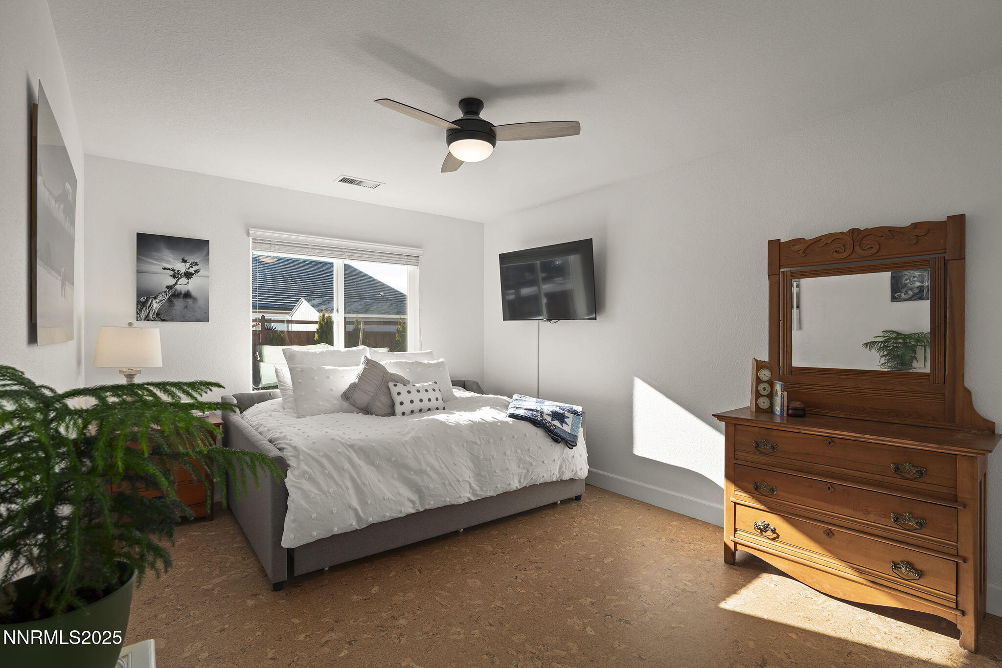 7707 Rhythm Circle Sparks, NV 89436 - Photo 16 of 30 a bedroom with a bed and wooden floor