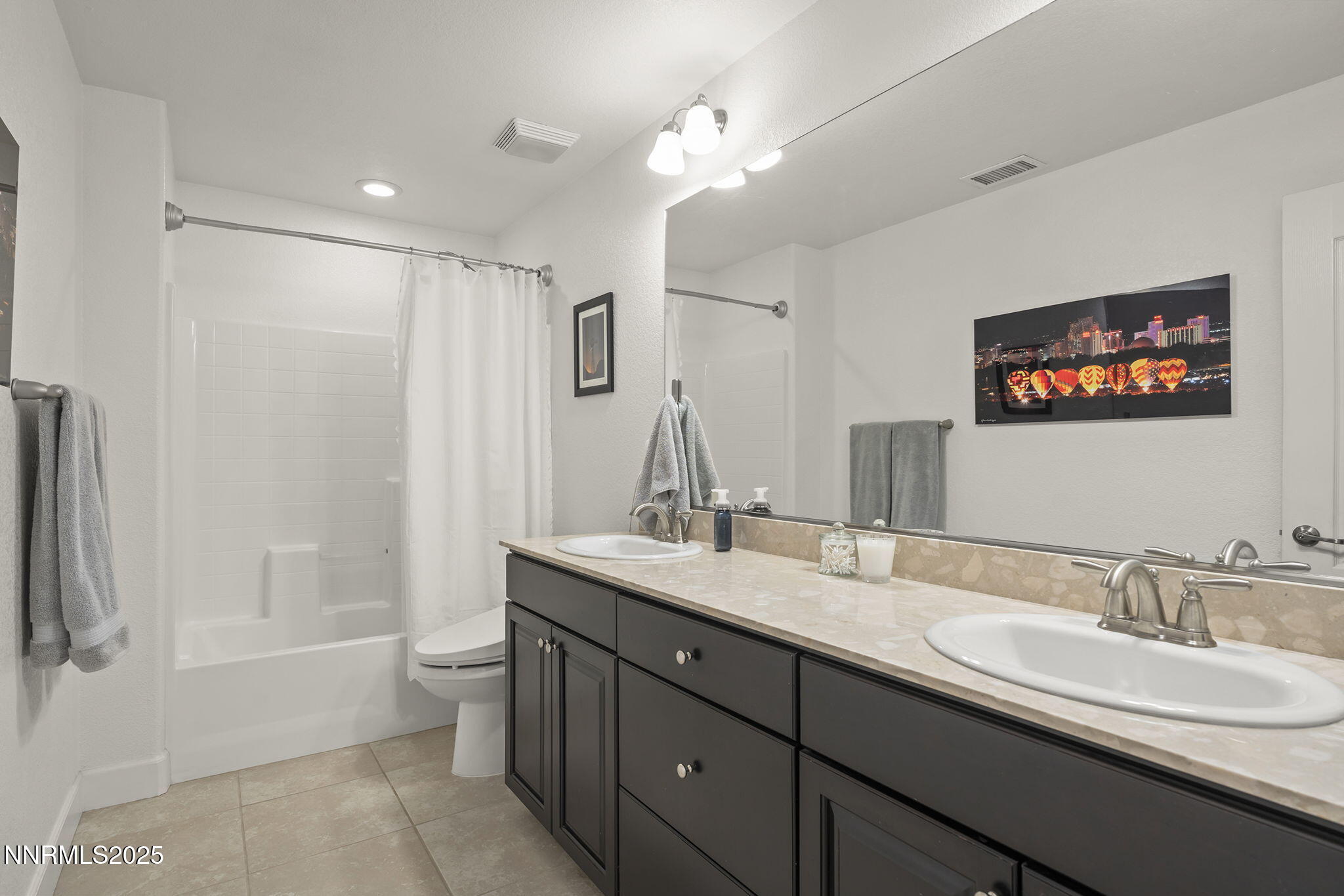 7707 Rhythm Circle Sparks, NV 89436 - Photo 18 of 30 a bathroom with 2 sink tub and a mirror