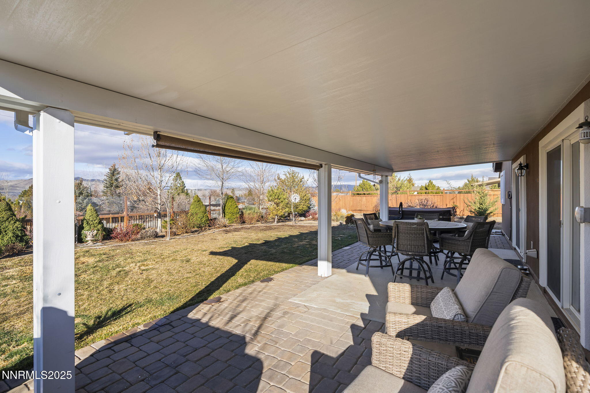 7707 Rhythm Circle Sparks, NV 89436 - Photo 20 of 30 a living room with couches floor to ceiling windows and a flat screen tv