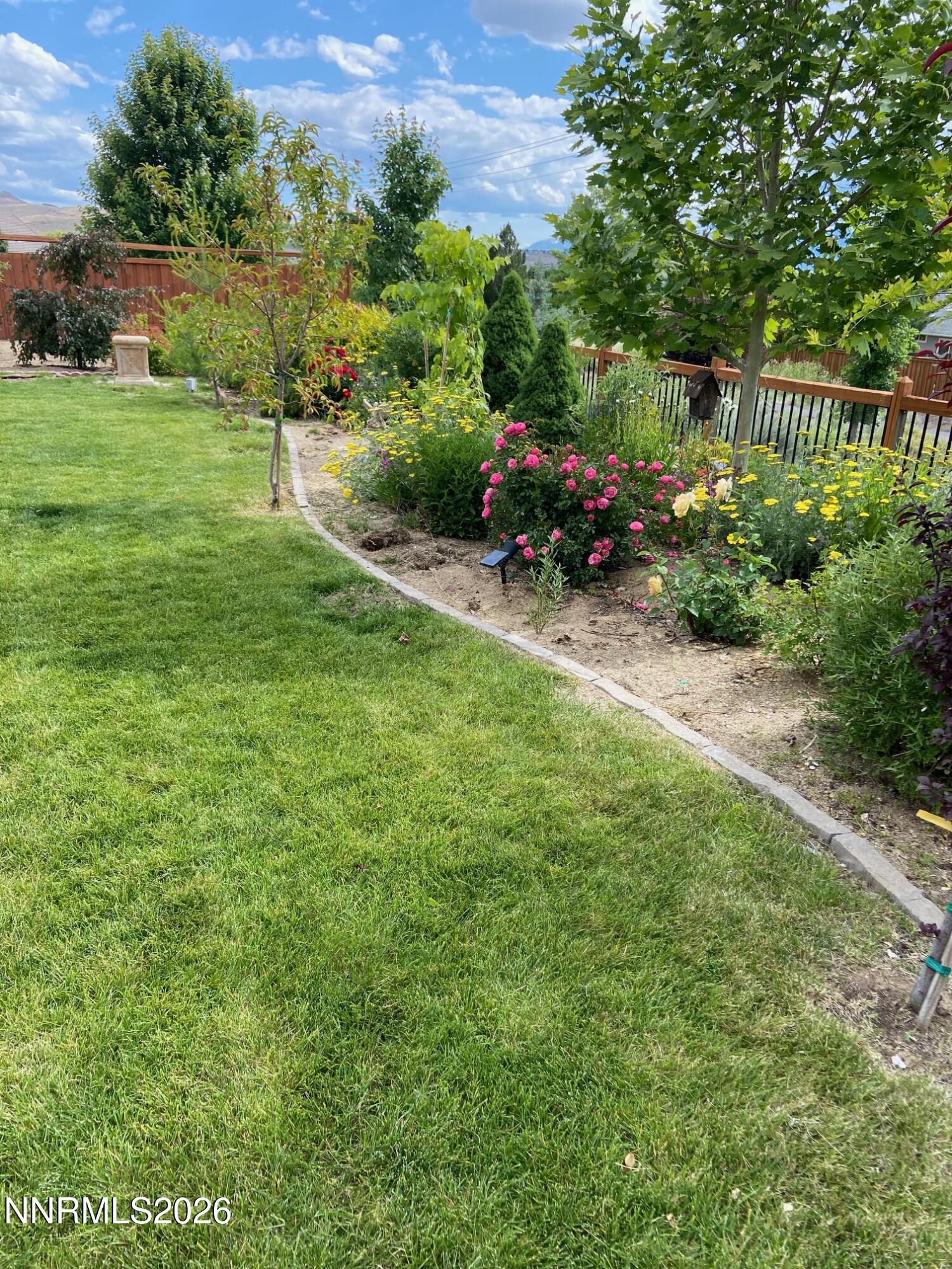 7707 Rhythm Circle Sparks, NV 89436 - Photo 26 of 30 a view of a garden with plants and large trees