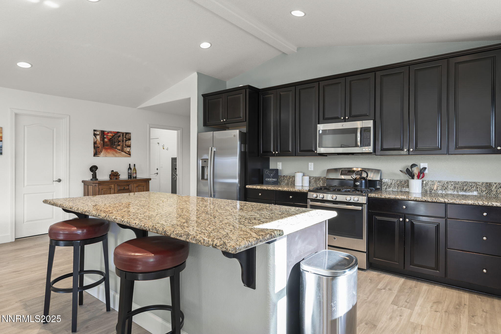 7707 Rhythm Circle Sparks, NV 89436 - Photo 10 of 30 a kitchen with stainless steel appliances granite countertop a stove top oven a sink refrigerator and cabinets