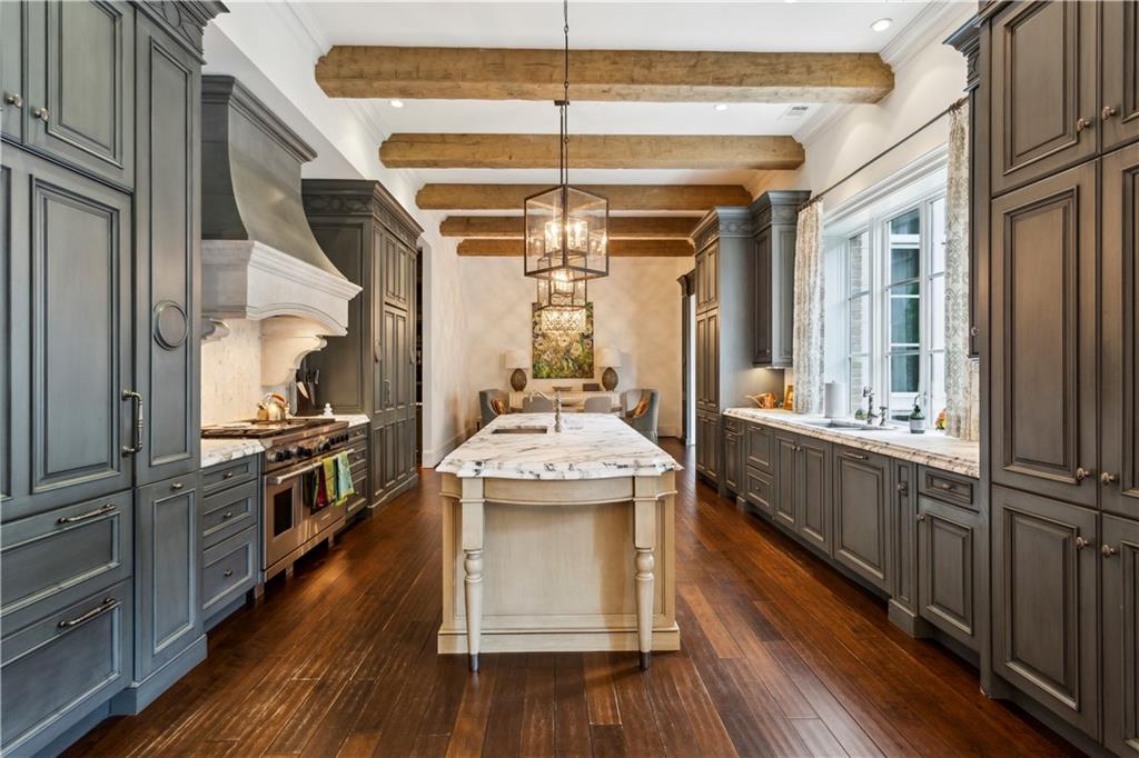 2440 Peachtree Road Northwest, Unit 6 Atlanta, GA 30305 - Photo 13 of 34 a kitchen with kitchen island granite countertop a stove and a wooden floors