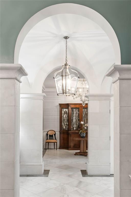 2440 Peachtree Road Northwest, Unit 6 Atlanta, GA 30305 - Photo 20 of 34 a view of a hallway with a chandelier and fireplace