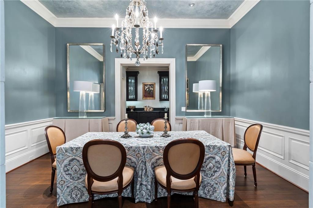 2440 Peachtree Road Northwest, Unit 6 Atlanta, GA 30305 - Photo 23 of 34 a dining room with furniture a chandelier and wooden floor